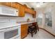 Bright kitchen boasts wood cabinets, a breakfast bar, and a sunlit window at 3010 Beecher E Dr # A, Palm Harbor, FL 34683