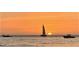 Tranquil ocean featuring a sailboat, motorboats, and vivid orange sunset at 3010 Beecher E Dr # A, Palm Harbor, FL 34683