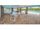 Covered outdoor patio area with ample seating, perfect for community gatherings and overlooking the community pool at 3010 Beecher E Dr # A, Palm Harbor, FL 34683