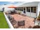 Spacious brick patio with outdoor dining set and lounge area, perfect for entertaining at 3010 Beecher E Dr # A, Palm Harbor, FL 34683