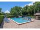 Community pool with comfortable lounge chairs, perfect for relaxing in the sun and enjoying the outdoors at 3010 Beecher E Dr # A, Palm Harbor, FL 34683