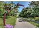 View of a paved path in Tarpon Springs, featuring a whimsical entrance sign and lush surroundings at 3010 Beecher E Dr # A, Palm Harbor, FL 34683