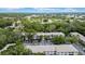 Aerial view of a building with lush landscaping, parking area, and pond at 3038 Eastland Blvd # F102, Clearwater, FL 33761