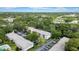 An aerial shot of building set among lush trees, parking, and a pool at 3038 Eastland Blvd # F102, Clearwater, FL 33761