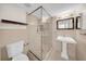 Clean bathroom featuring a glass-enclosed shower and pedestal sink at 3038 Eastland Blvd # F102, Clearwater, FL 33761