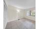 Bedroom features a window with natural light and ceramic tile at 3038 Eastland Blvd # F102, Clearwater, FL 33761