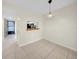 Dining area with tile floors, open to kitchen with countertop passthrough at 3038 Eastland Blvd # F102, Clearwater, FL 33761