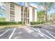 Well-maintained condo building with lush landscaping, mature trees, and convenient parking at 3038 Eastland Blvd # F102, Clearwater, FL 33761