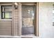Neutral front door with a screen, number 102, and secured with a lockbox at 3038 Eastland Blvd # F102, Clearwater, FL 33761
