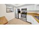 Efficient kitchen featuring stainless steel appliances, white cabinets, and tile flooring at 3038 Eastland Blvd # F102, Clearwater, FL 33761