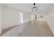 Bright living room featuring neutral tile flooring and decorative pendant lighting at 3038 Eastland Blvd # F102, Clearwater, FL 33761