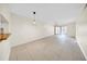 Spacious living area featuring neutral walls, tile flooring and modern hanging light fixture at 3038 Eastland Blvd # F102, Clearwater, FL 33761