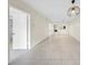 Open-concept living area with tile flooring and contemporary pendant lighting at 3038 Eastland Blvd # F102, Clearwater, FL 33761