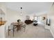 Open-concept living and dining area featuring tile flooring and modern lighting fixtures at 3038 Eastland Blvd # F102, Clearwater, FL 33761