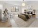 Cozy main bedroom with neutral decor, accent chair, and a large window at 3038 Eastland Blvd # F102, Clearwater, FL 33761