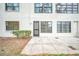 Outdoor patio with textured concrete and view of building facade, providing a relaxing outdoor space at 3038 Eastland Blvd # F102, Clearwater, FL 33761