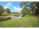 Picturesque pond view surrounded by lush greenery and mature trees, offering a serene outdoor space at 3038 Eastland Blvd # F102, Clearwater, FL 33761