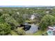 Scenic aerial view of a building near a serene pond surrounded by mature trees at 3038 Eastland Blvd # F102, Clearwater, FL 33761