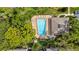 Overhead shot of a rectangular pool surrounded by lounge chairs and greenery at 3038 Eastland Blvd # F102, Clearwater, FL 33761