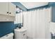 Cozy bathroom features blue walls, a white sink, a toilet, and a shower curtain at 307 Francis Dr, Apollo Beach, FL 33572