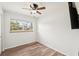 Clean bedroom featuring white walls, wood-look floors, a ceiling fan, and a TV at 307 Francis Dr, Apollo Beach, FL 33572