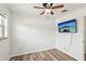 Clean, vacant bedroom featuring white walls, wood-look floors, and a television at 307 Francis Dr, Apollo Beach, FL 33572