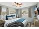 Comfortable bedroom featuring a ceiling fan, a TV and beautiful sunlight at 307 Francis Dr, Apollo Beach, FL 33572