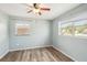 Empty bedroom featuring light blue walls, a ceiling fan, and wood-look floors at 307 Francis Dr, Apollo Beach, FL 33572