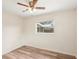 Bright bedroom featuring wood-look floors, and a window view to the outside at 307 Francis Dr, Apollo Beach, FL 33572