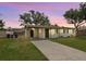 Charming single-story home with a covered carport, lush green lawn, and a welcoming driveway at 307 Francis Dr, Apollo Beach, FL 33572