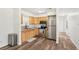 Well-lit kitchen featuring stainless steel appliances, wood cabinets, and modern flooring at 307 Francis Dr, Apollo Beach, FL 33572