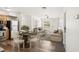 Bright living area open to dining, featuring stylish decor and wood-look floors at 307 Francis Dr, Apollo Beach, FL 33572