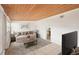 Cozy living room featuring a wood-plank ceiling, comfortable seating, and a stylish rug at 307 Francis Dr, Apollo Beach, FL 33572