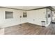 Enclosed patio featuring a wood deck, white walls, and a trash can at 307 Francis Dr, Apollo Beach, FL 33572