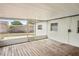 Enclosed patio featuring a wood deck, white walls, and a view of the yard at 307 Francis Dr, Apollo Beach, FL 33572