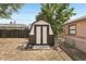 Outdoor shed in the backyard with wooden frame and concrete base against a chain link fence and wood fence at 307 Francis Dr, Apollo Beach, FL 33572