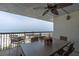 Relaxing balcony features comfortable seating, a ceiling fan, and stunning views of the beach and ocean at 3200 Gulf Blvd # 202, St Pete Beach, FL 33706