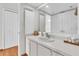 Bright bathroom with a large mirror, white cabinets, and ample counter space at 3200 Gulf Blvd # 202, St Pete Beach, FL 33706