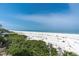 Scenic beach view showcasing the white sands meeting the ocean under a clear sky, highlighting the property's tranquil setting at 3200 Gulf Blvd # 202, St Pete Beach, FL 33706