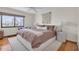 Comfortable bedroom featuring a king bed, soft lighting, and a large window at 3200 Gulf Blvd # 202, St Pete Beach, FL 33706