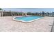 Inviting community pool area featuring comfortable lounge chairs and a pergola, ideal for relaxation and social gatherings at 3200 Gulf Blvd # 202, St Pete Beach, FL 33706