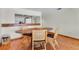 Cozy dining space with wood floors and seating for four by a pass-through kitchen at 3200 Gulf Blvd # 202, St Pete Beach, FL 33706