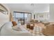 Inviting living room featuring stylish furnishings, wood floors, and sliding glass doors to balcony at 3200 Gulf Blvd # 202, St Pete Beach, FL 33706
