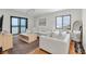 Spacious living room featuring a large sectional sofa, natural light, and ocean view through sliding doors at 3200 Gulf Blvd # 202, St Pete Beach, FL 33706