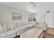 Bright living room featuring a plush white sectional sofa and neutral decor at 3200 Gulf Blvd # 202, St Pete Beach, FL 33706