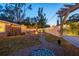 Spacious backyard with a fire pit, hammock, patio set, and string lights at 3245 Freemont S Ter, St Petersburg, FL 33712