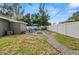 Spacious backyard with a stone fire pit, patio seating, lush lawn, and a charming gravel pathway at 3245 Freemont S Ter, St Petersburg, FL 33712