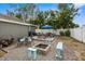 Backyard featuring a stone fire pit, patio seating, lush lawn, and a built-in barbecue at 3245 Freemont S Ter, St Petersburg, FL 33712