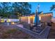 Cozy backyard with string lights, a fire pit, patio furniture, and a well-maintained lawn at 3245 Freemont S Ter, St Petersburg, FL 33712