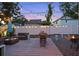 A deck with outdoor seating and string lights makes the backyard an ideal space for relaxing and entertaining at 3245 Freemont S Ter, St Petersburg, FL 33712
